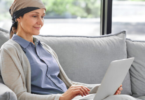 woman with cancer using laptop